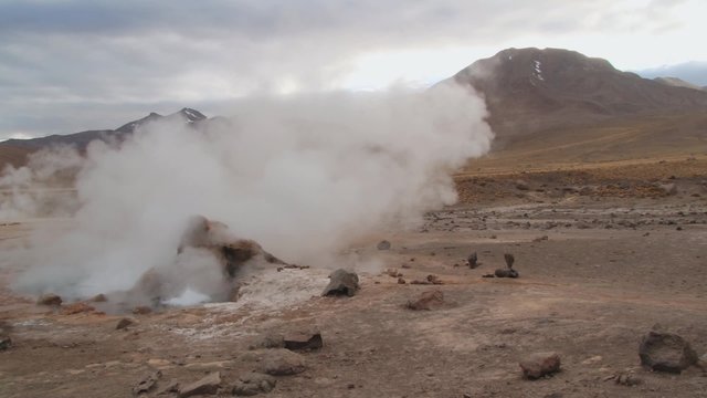 El Tatio geyser boils and produces steam at sunrise at the famous El Tatio geyser valley at 4320 meters above sea level,  Chile.