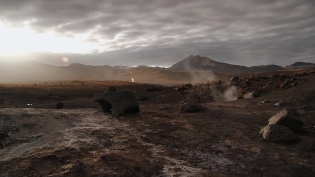 El Tatio geysers steam at sunrise at the famous El Tatio geyser valley at 4320 meters above sea level,  Chile.