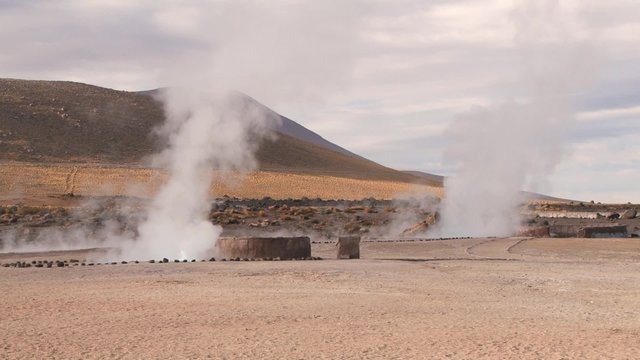 El Tatio geysers steam at sunrise at the famous El Tatio geyser valley at 4320 meters above sea level,  Chile.