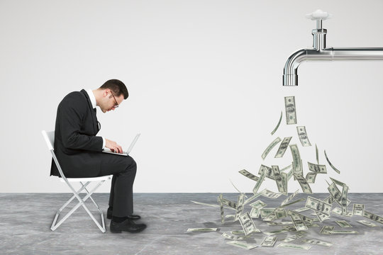 Businessman working opposite flow of dollars from the faucet con