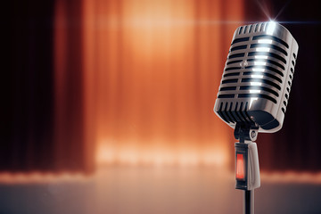 Naklejka premium Vintage microphone at stage background