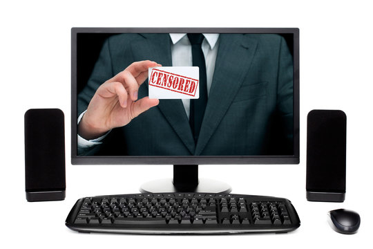 Man on desktop computer monitor showing card with sign "censored"