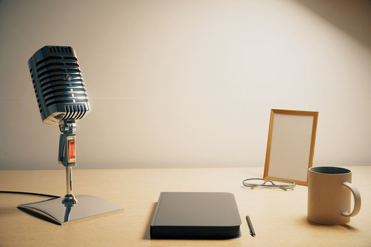 Radio microphone with diary, cup of coffe and blank picture fram
