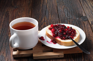 Cup of tea and bread with jam