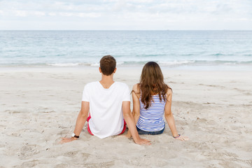 Romantic young couple sitting on the beach