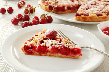 Tasty homemade pie with cherries on table close up