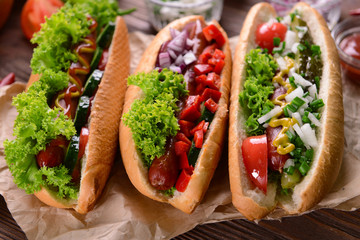 Hot dogs and vegetables on craft paper closeup