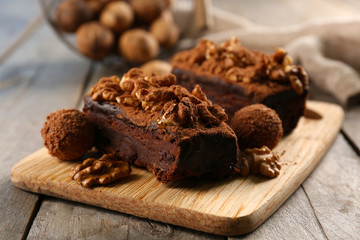 Pieces of chocolate cake with walnut on the table, close-up