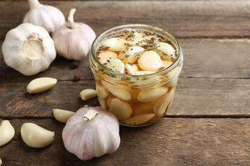 Garlic with spices on wooden table