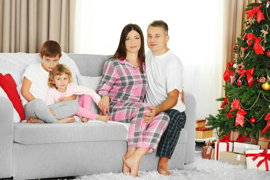 Christmas family portrait in home holiday living room, at christmas morning