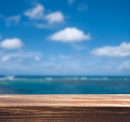 Fototapeta na wymiar Wood table top with blur sea background