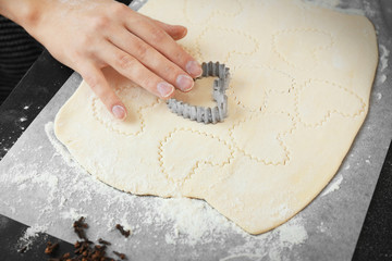 Woman cooking biscuits in kitchen