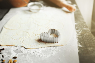 Uncooked heart shaped biscuits on a table