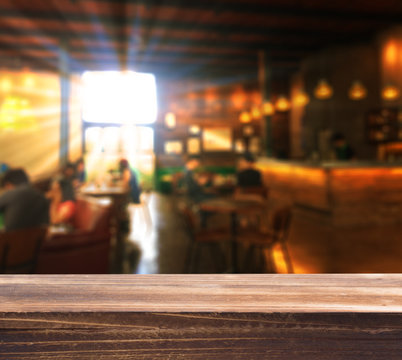 Wood tabletop with blur coffee shop background