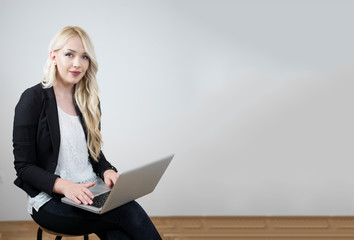 Happy entrepreneur working with a phone and laptop