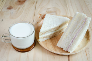 sandwich with milk on wood background