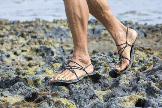 Walking in sandals on coral reef