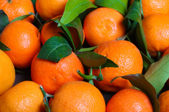background Bunch of fresh tangerines oranges on market
