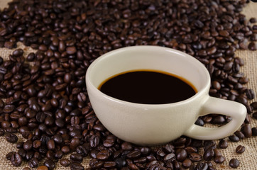 Dark coffee cup and roast coffee beans