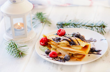Christmas sweet breakfast. Crepes with berries.