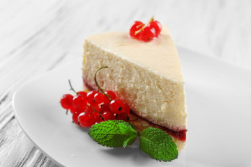 Delicious cheesecake with berries on table close up