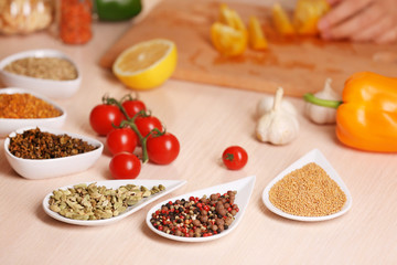 Variety of spices in ceramic containers on the kitchen table