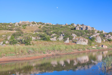 moon over rocky hill