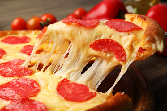 Hot tasty pizza with salami, close up