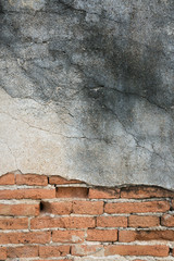 Old concrete wall with bricks background