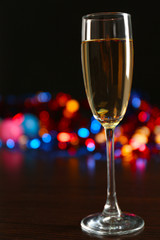 A glass of champagne with bokeh on dark background