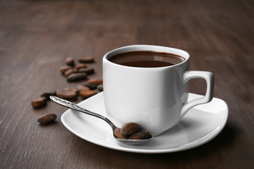 Cacao with beans and chocolate on wooden background
