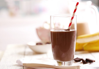 Glass of chocolate milk on table close-up