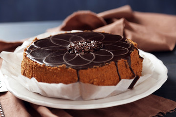 Tasty chocolate cake on wooden background