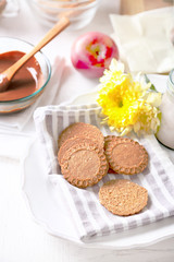 Melted chocolate on glass bowl, on wooden background