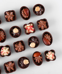 Delicious chocolate candies on white background