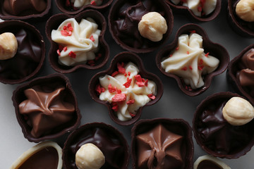 Composition of chocolate candies on white background, close up