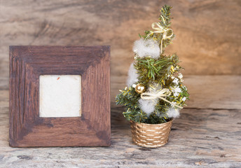 Wooden frame and Christmas tree  on grunge wooden background