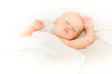 Peaceful baby lying on a bed sleeping