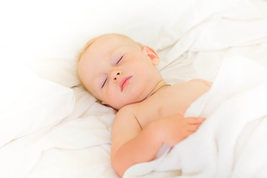 Peaceful baby lying on a bed sleeping