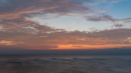 Naklejka na ściany i meble Colorful of sunrise on the ocean beach