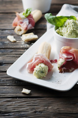 Italian grissini with cream cheese and prosciutto