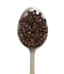 black pepper spices on spoon over white background