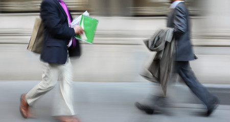 motion blurred business people walking on the street