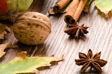Walnuts, cinnamon sticks, star anise and autumn leaves