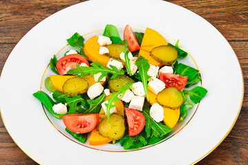 Healthy and Diet Food: Salad, Persimmon, Pickled Cucumber, Tomat