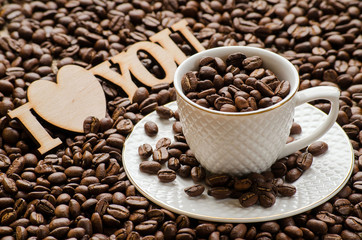 Scattered grains of coffee, Cup with saucer and a wooden plate