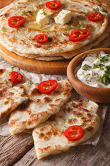 hot paratha and yogurt  close-up on the table. vertical
