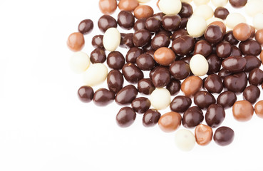 small chocolate balls closeup on a white background