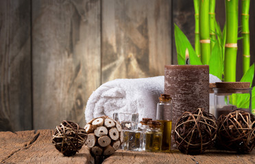 spa massage setting, product, oil on wooden background