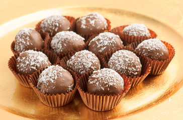 balls of chocolate covered coconut on golden tray
